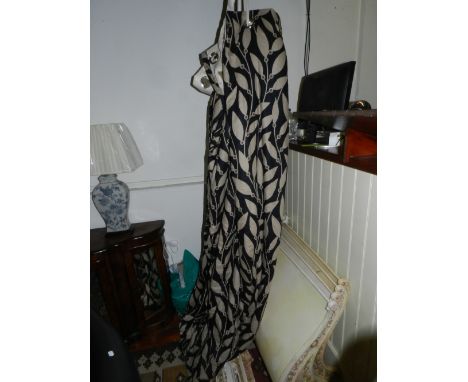 A pair of quality leaf print design lined curtains with metal eyelets each 215 x 300 cms together with a pair of floral print