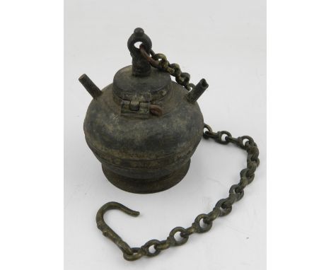 An early 20th century cast metal Indian incense burner, with chain and hook.