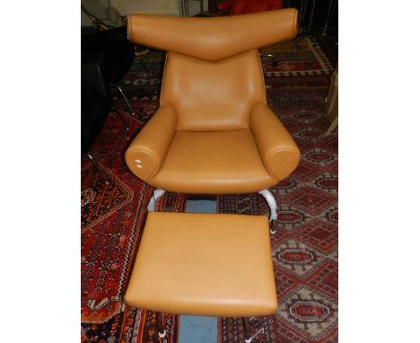 In the manner of Hans Wenger, an Ox chair, upholstered in light brown leather, together with a foot stool, (2).