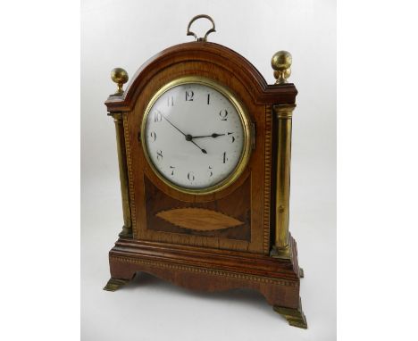 An early 20th century mantel timepiece, the mahogany case with brass finials and handle to top, having giltwood columns flank