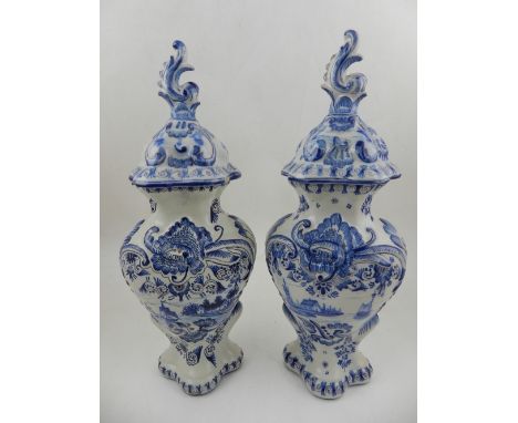 Two late 19th / early 20th century Delftware blue and white jars with covers, decorated with vignettes of boats at sea on a f