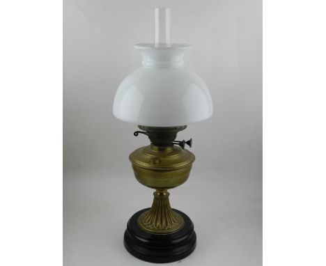 A late Victorian brass oil lamp, with opaque white glass shade, H. 57cm