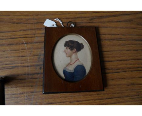 Oval portrait miniature on card 19thc young lady in blue dress left facing profile. 7cms.