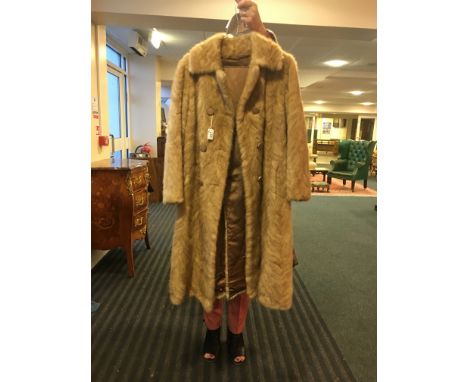 Pale mink tail fur coat, pale patch to one side.