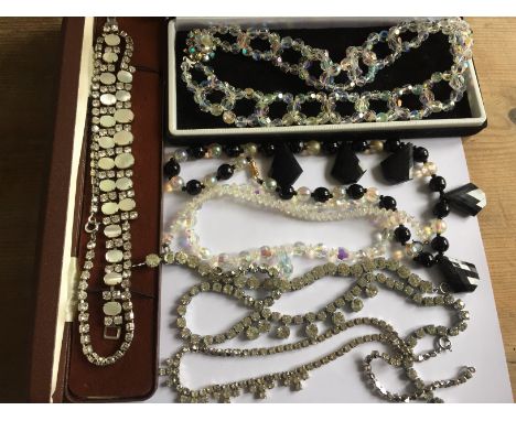 A quantity of vintage diamante and bead necklaces.