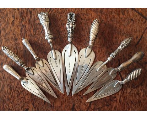 Nine silver trowel bookmarks.