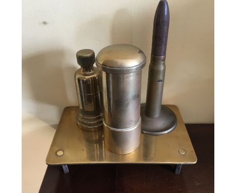 Four items of shell trench art including 2 cigarette lighters.