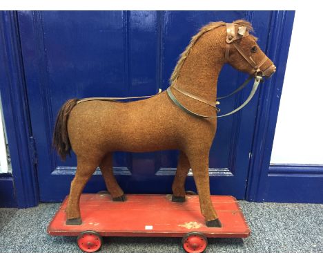 Vintage pull along horse on wheels. 63cms long.