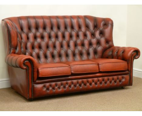 Wing back three seat sofa upholstered in red buttoned leather, W175cm