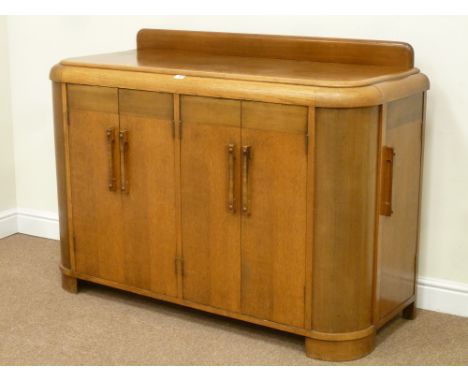 Art Deco period light oak sideboard with curved ends, two double cupboards, right hand side interior fitted with three drawer