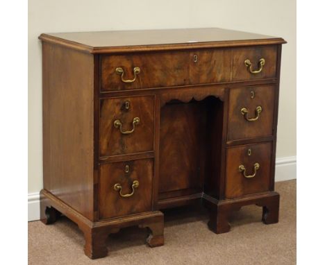 George II mahogany kneehole writing desk/dressing table the rectangular figured top with quarter moulded edge leading deep lo