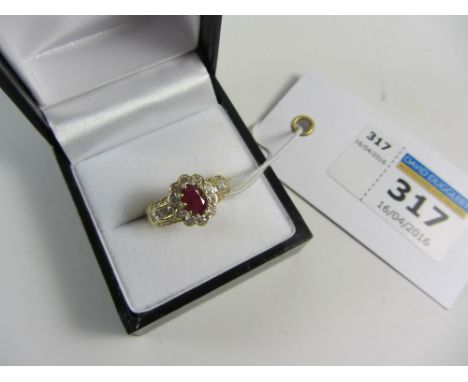 Oval ruby and diamond cluster ring hallmarked 18ct