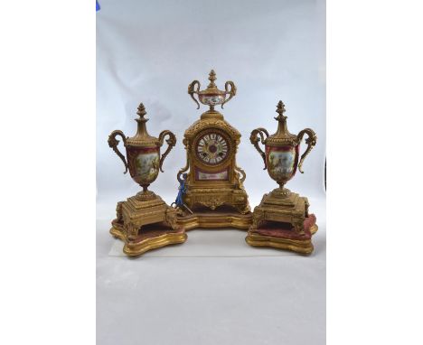 Gilt metal and hand painted porcelain three piece mantle clock garniture, late C19th/early C20th,&nbsp;the clock decorated wi