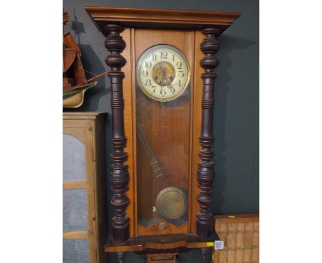 19th/20th century German style wall clock. Ceramic face with brass surround and brass pendulum with carved Cherub and rearing