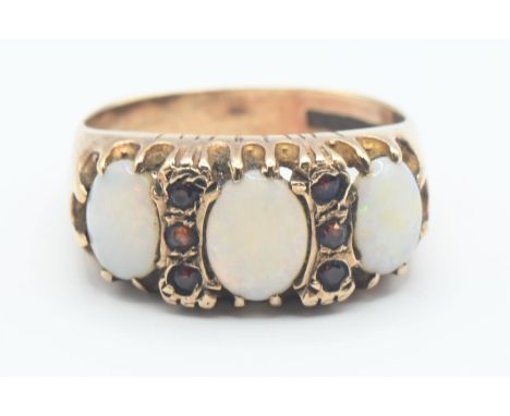 9ct gold, opal and red stone ring. Hallmarked Birmingham 1973, size Q. Gross weight 4.8g.