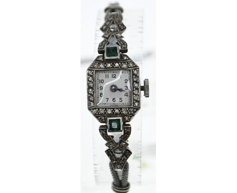 Platinum cased Art Deco watch set with diamonds and green stones on a white metal strap (testing positive for platinum.) Gros
