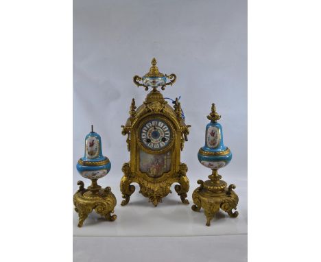 Gilt metal and hand painted porcelain three piece mantle clock garniture, late C19th/early C20th, decorated in turquoise with