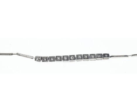 Art Deco diamond bracelet. 11 old cut diamonds set in white metal with tongue and box clasp. Circumference 180mm. Gross weigh