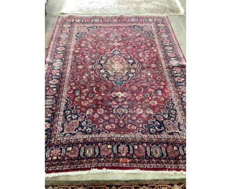 A Tabriz burgundy ground floral carpet 334 x 224cm