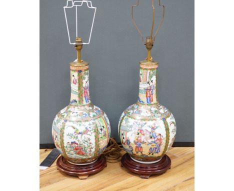 A pair of Chinese famille rose lamp bases on wooden stands, 50cm high