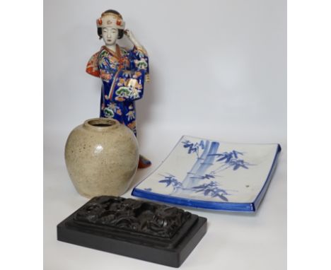 A 20th century Chinese porcelain figure, a stoneware jar, a ‘dragon’ inkstone and a Japanese dish, figure 37cm