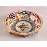 A JAPANESE MEIJI PERIOD IMARI DECAGON SHAPED PORCELAIN BOWL, with underglaze blue Shi shi dog,