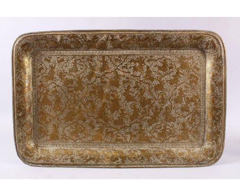 A GOOD PERSIAN QAJAR ENGRAVED HUNTING SCENE BRASS TRAY, carved with various hunting scenes, around scrolling foliate decorati