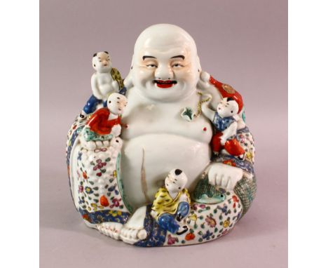 A GOOD CHINESE REPUBLIC PERIOD FAMILLE ROSE PORCELAIN FIGURE OF BUDDHA, seated with young attendant, the base with an oval im