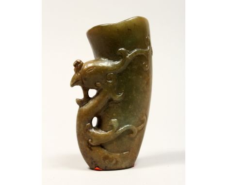 A CHINESE CARVED JADE LIBATION CUP, 5ins high.