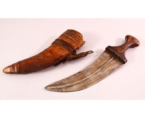 AN ARAB JAMBIYA DAGGER, with horn handle and hide scabbard, 31cm long.