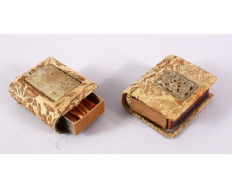 TWO CHINESE CARVED JADE INSET MATCH BOX HOLDERS, each inset with a small carved jade pendant, two figures and a swastika, and