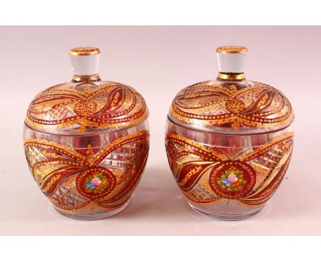 A PAIR OF BOHEMIAN RED ENAMELLED GLASS JARS, each with enamel and gilt work, 20cm each