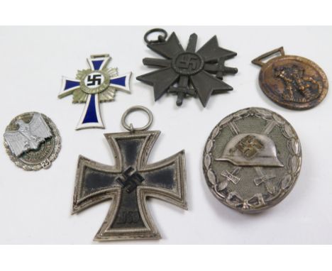 German WW2 medals and badges including WW2 Iron Cross 2nd Class, Silver Wounds Badge, Merit Cross with Swords, etc (6)