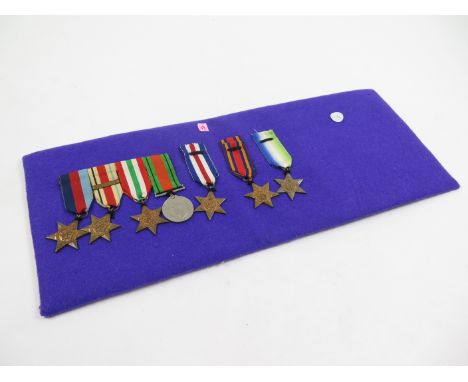WW2 medals mounted on purple baize - 1939-45 Star, Africa Star + 1st Army clasp, Italy Star, Defence Medal, F & G Star, Burma