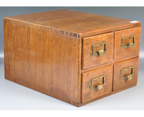 An early 20th Century vintage&nbsp;industrial oak index desktop filing cabinet. The cabinet consisting of four drawers with e