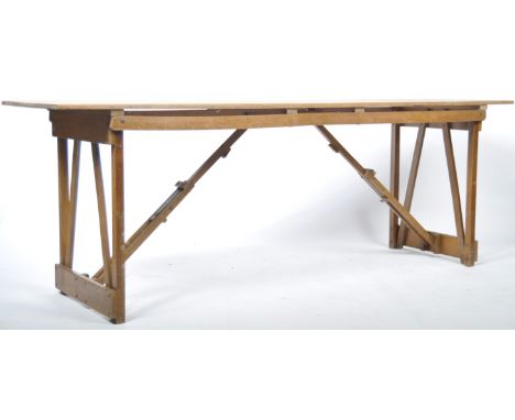 A good mid 20th Century retro vintage industrial folding wooden trestle table having A planked table top with folding wooden 