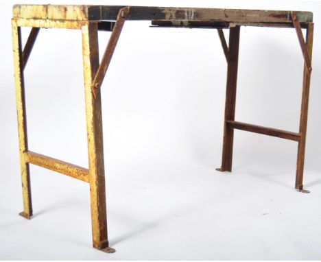 A mid 20th Century retro vintage industrial console / workman's trestle folding table having a rustic yellow painted steel fr