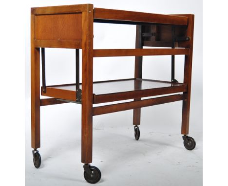 A mid 20th Century 1950's retro vintage teak wood two tier revolving campaign style tea trolley / cocktail trolley. The troll