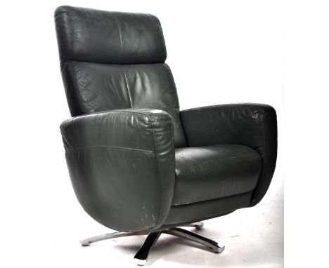 A 20th Century retro vintage green leather reclining armchair / arm chair having a sectional padded back rest with broad shie