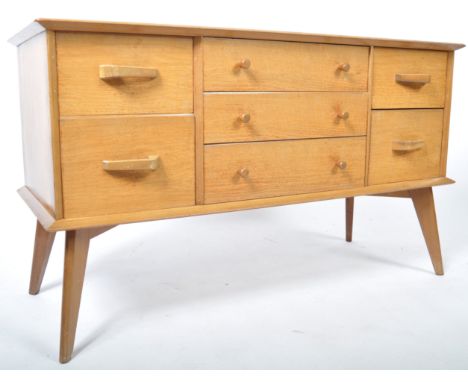 A fabulous mid 20th Century light oak sideboard credenza in the manner of G Plan Brandon Range. The sideboard having a flared
