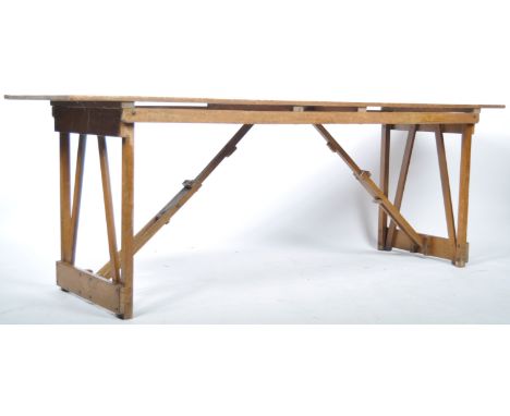 A good mid 20th Century retro vintage industrial folding wooden trestle table having A planked table top with folding wooden 