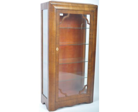 A fantastic early 20th Century Art Deco retro vintage walnut display cabinet vitrine having a glazed panel door with glass sh