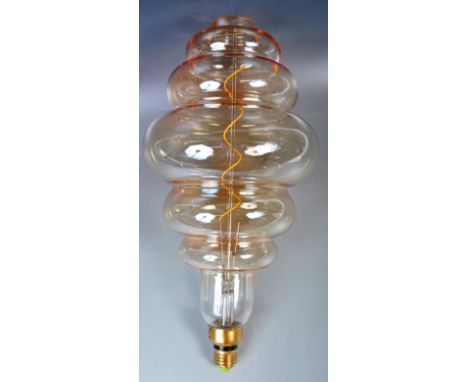 A large contemporary LED dimmable beehive Edison Bulb E27. The lamp light bulb having orange finish to the glass. Measures 41