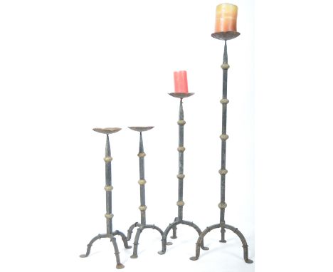 A good group of four 19th Century Victorian antique iron worked set of graduating candlesticks / candle holders of ecclesiast
