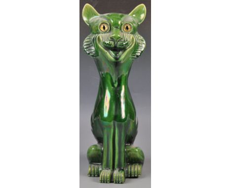 An unusual early to mid 20th Century retro vintage ceramic green glazed cat moulded in an upright seated position set with gl