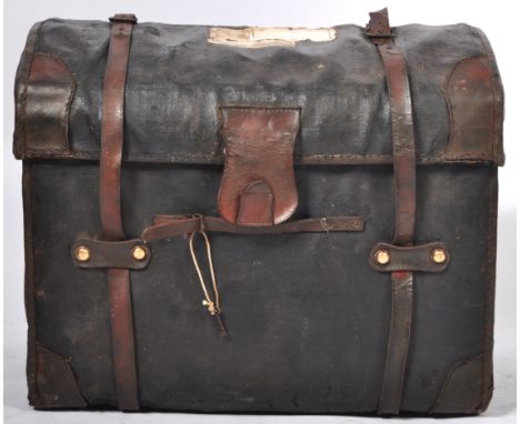A fabulous 19th Century Victorian antique domed top travelling trunk having an ebonised canvas body with brown leather mounts