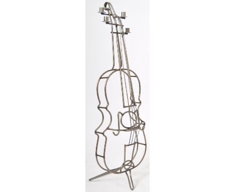 A contemporary retro vintage style wire worked free standing candlestick holder in the form a cello musical instrument. The c