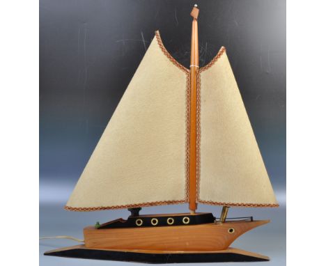 A good mid 20th Century retro vintage teak&nbsp;wood table / bedside lamp light in the form of a boat having two shades formi