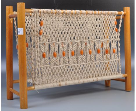 A 20th Century retro vintage light oak magazine rack having a white cord woven decoration to the sides and orange bead detail