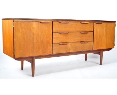 A 20th Century retro vintage teak wood sideboard credenza in the manner of Macintosh having a central bank of three drawers f